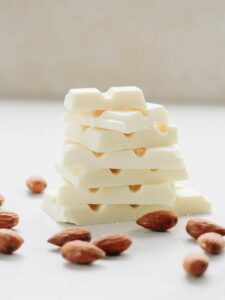 shallow focus photo of brown peanuts, white chocolate