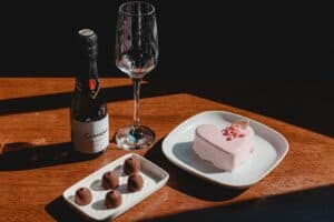Strawberry Cake on White Ceramic Plate Beside Wine Glass
