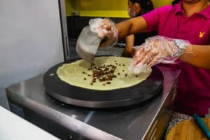 Lady preparing to cook a chocolate crepe