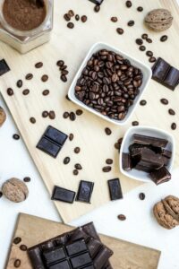 Chocolate chunks and coffee beans on a white table