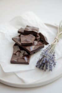 chocolate bars beside flower on white tray