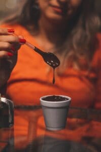 Photo Of Woman Holding Spoon Of Melted Chocolate