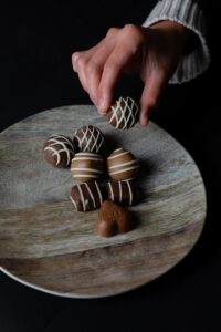 person holding a chocolate truffle